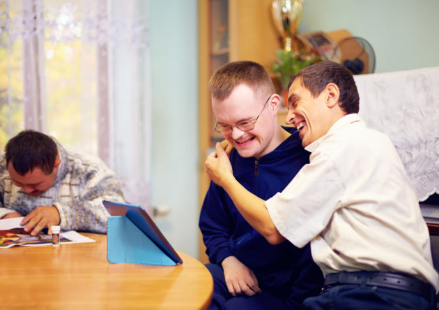 People with intellectual disabilities smiling and hugging
