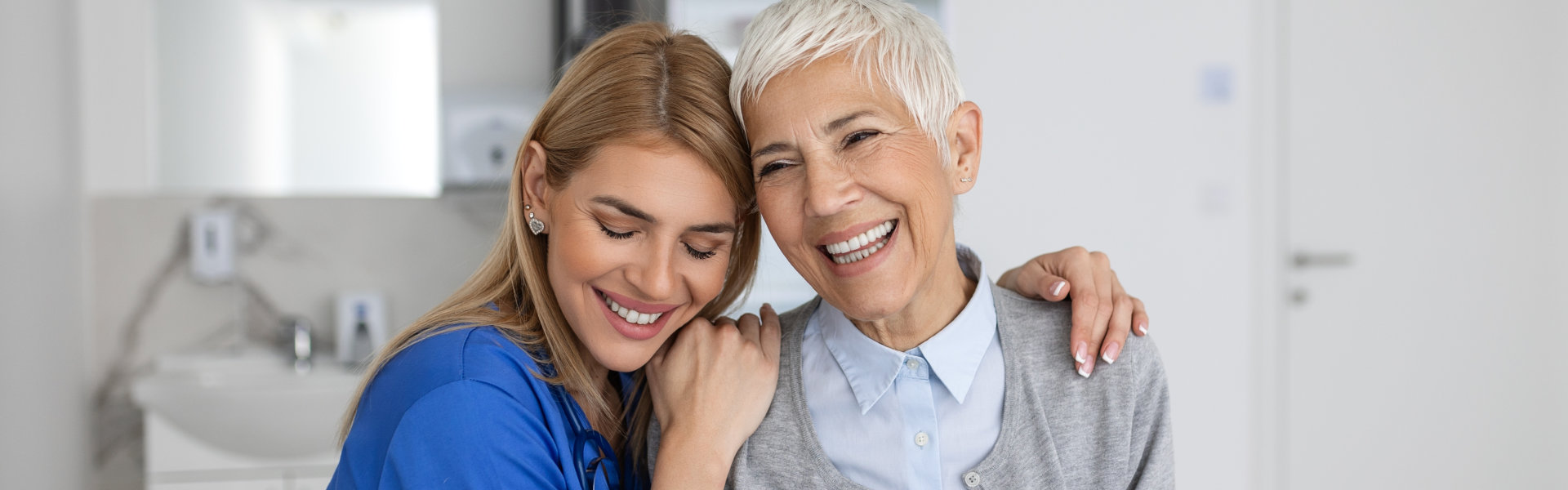 caregiver embracing the elderly woman